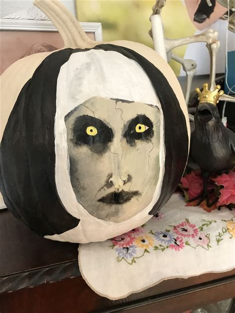 A Pumpkin Decorated With A Painting Of A Woman S Face