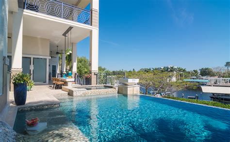 Infinity edge pool with champagne spa and carrara white marble deck. Insane Pools TV Episode Dream Mulligan | Lucas Lagoons