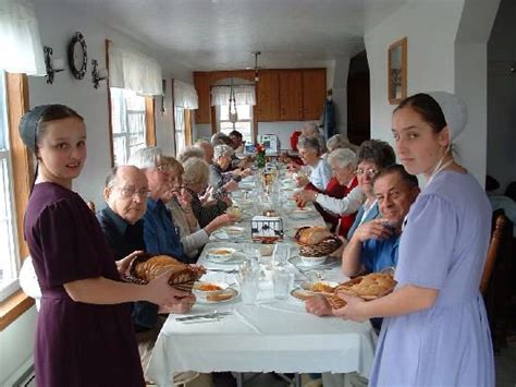 Visitors Enjoy A Meal In An Amish Home Amish