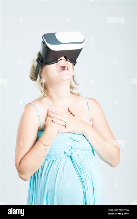 Blonde Beautiful Pregnant Girl Wearing 3d Virtual Reality Goggles Isolated On Background