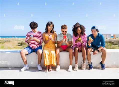 Multiethnic Group Of Young Happy Friends Bonding Outside Having Fun On