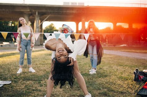 Smiling Woman Performing Limbo Dance At Lawn In Music Festival Stockphoto