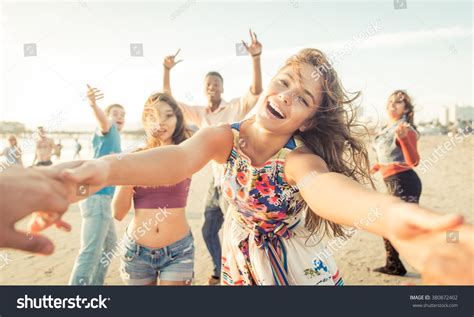 Group Of Friends Having Fun And Dancing On The Beach Spring Break
