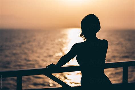 Silhouette Of Young Anonymous Woman Standing On Cruise Ship Deck