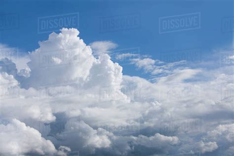 Puffy Clouds In Sunny Blue Sky Stock Photo Dissolve