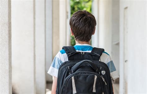 Teenage School Boy With A Backpack Walking To School Stock Photo