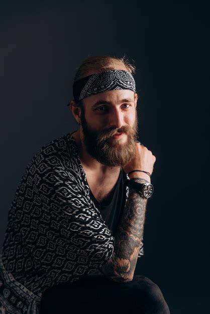 Premium Photo Portrait Of A Guy With A Beard And Tattoos On A Dark Background Hipster