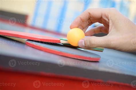 Male Hand Holds Ping Pong Ball On Small Tennis Table In Outdoor Sport