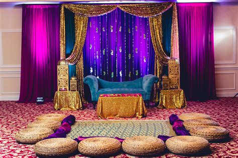 Bold Gem Tones For The Mehndi Sangeet Dholki Stage Backdrop Desi Wedding Decor Wedding Stage