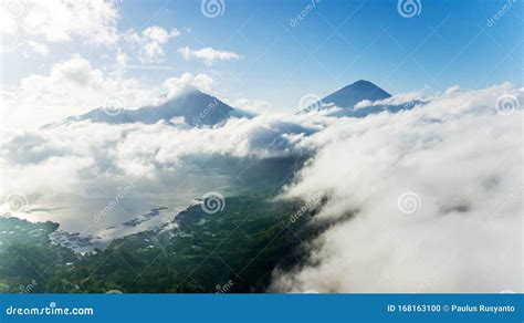 Mountain Surrounded By Clouds Upon Lake And Forest Stock Photo Image