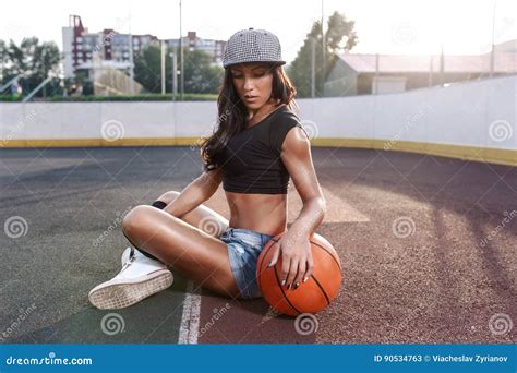 Beautiful Brunette Woman Playing Basketball On Court Outdoor Stock
