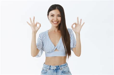 Free Photo Self Assured Good Looking Friendly Woman With Cropped Blouse Showing Okay Gesture