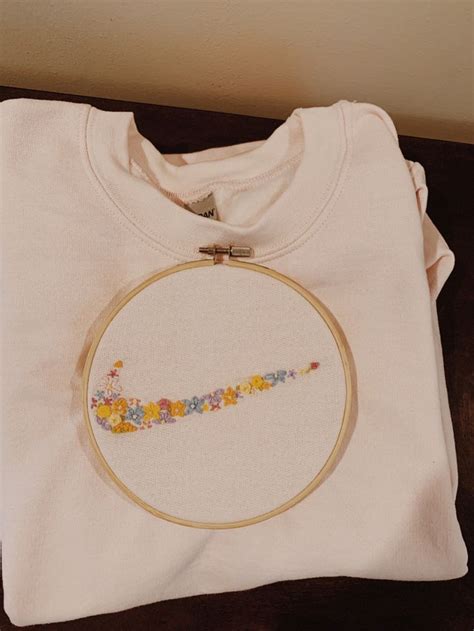 Sweatshirt diy can also be a fun and quirky way of expressing your personality and interests, with graphic prints ranging from your favorite cartoons and games to tv shows and bands. Nike swoosh embroidered flowers on pink crewneck | Diy embroidery shirt, Diy embroidery designs ...