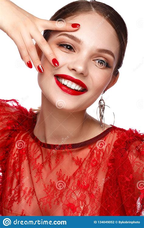 Beautiful Girl In Red Dress With Classic Make Up And Red Manicure
