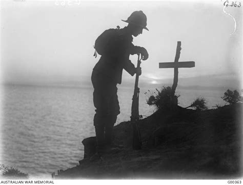 A British Soldier Visits His Comrades Grave On The Cliffs On The Tip