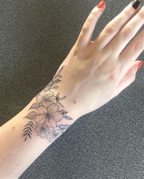 my wrap around wrist of flowers done by laura morkūnaitė at ink factory kaunas lithuania r