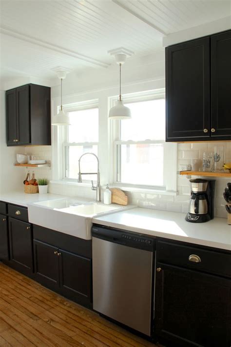 In contemporary kitchen design, there is not much earth color for black to. black kitchen cabinets, ikea farmhouse sink, white ...