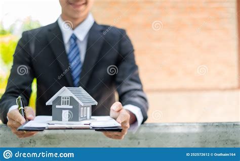 Home Insurance Concept And Real Estate Business Asian Man Holding A