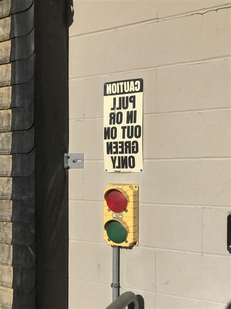This Loading Dock Has Signs Written Backwards So Drivers Can Read Them