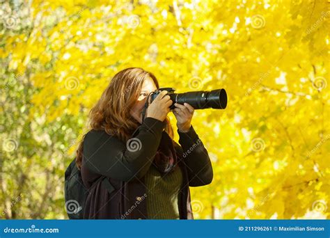 Photographer Woman With Camera And Telephoto Lens Photographing Nature
