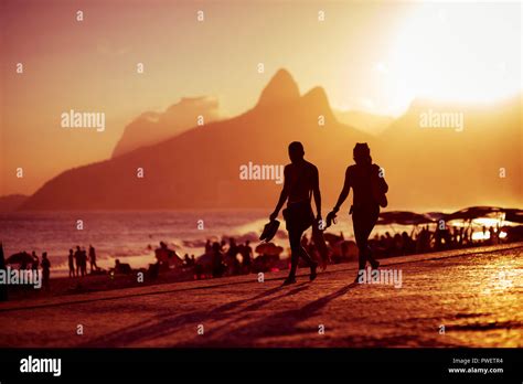 Scenic Golden Sunset View Of Ipanema Beach With Shadow Silhouettes