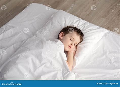 Tired Little Boy Sleeping In Bed Happy Bedtime In White Bedroom Stock