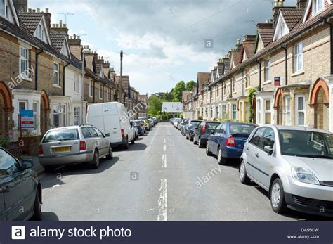 Cars Parked Along Both Sides Of The Road Dorset England Stock Photo