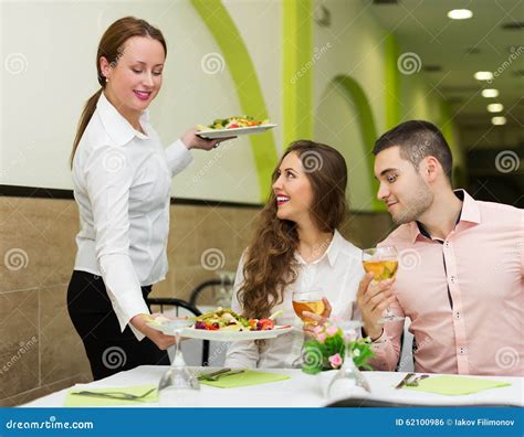 Waitress Serving Food To Visitors Stock Photo Image Of Interior
