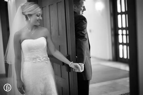 Bride And Groom Holding Hands Around Door Kansas City Wedding