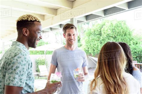 Smiling Friends With Cold Drinks Talking Outdoors Stock Photo Dissolve