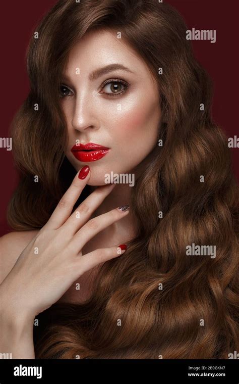 Beautiful Girl With A Classic Make Up Curls Hair And Red Nails