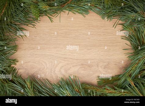 Traditional Pine Tree Christmas Border Decoration On A Wood Background