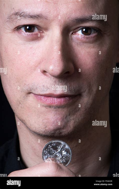 Magician With Coin Stock Photo Alamy