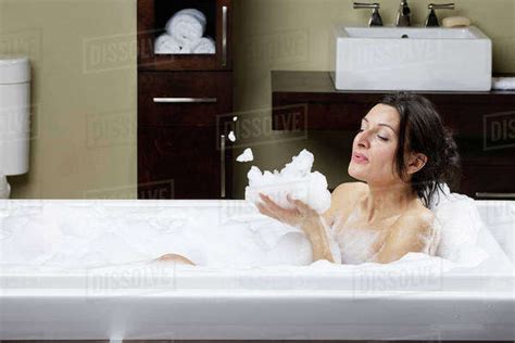 Caucasian Woman Blowing Bubbles In Bubble Bath Stock Photo Dissolve