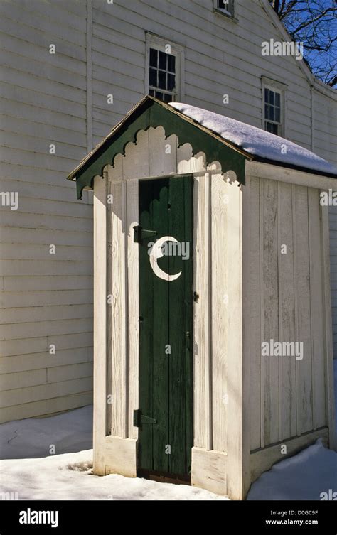 Outhouse Door And Historic Outhouse Door With A Quarter Moon Face In Snow