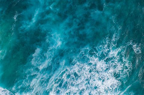 Bali Aerial Shot Of The Turquoise Ocean Surface With Waves Stock Photo