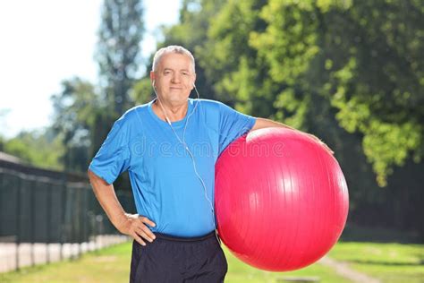 Mature Man Holding A Fitness Ball In Park Stock Image Image Of Coach