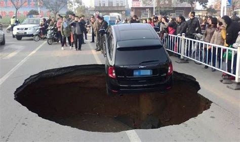 Massive Pothole Attempts To Swallow Car Uk News Uk