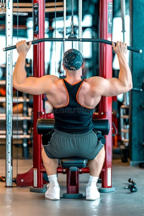 Exercise Of The Back Muscles By Pulling The Pulley On The Strength