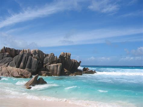 Beach Shore With Stone Cliff During Day Time La Digue Seychelles Hd