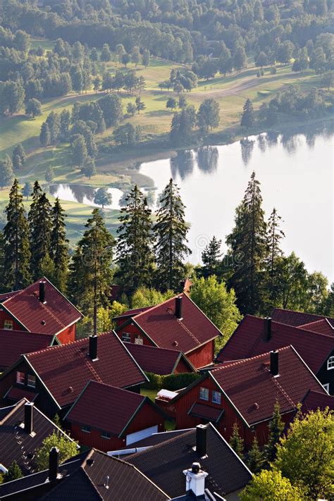 Scandinavian Village With Scenic Lake And Misty Landscape Stock Image