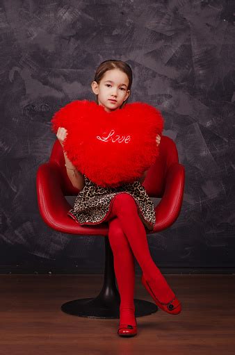 Pretty Little Girl Wearing Beautiful Dress Sitting In Red Armchair