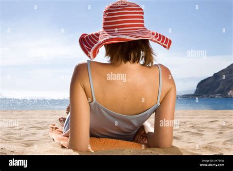 Woman Lying On Beach Rear View Stock Photo Alamy