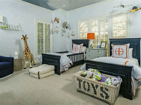 A nautical themed twin boys bedroom using navy, red and cream. Double twin bed kids room with beds in front of windows ...