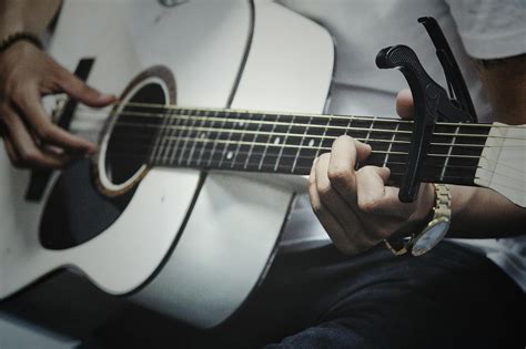 Man Holding A White Dreadnought Acoustic Guitar · Free Stock Photo