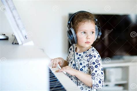 Beautiful Little Kid Girl Playing Piano In Living Room Or Music School