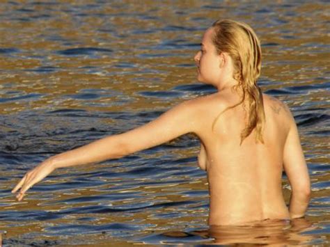thumbs pro toplessbeachcelebs Dakota JohnsonÂ swimming topless in