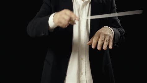 The Hands Of An Orchestra Conductor Directing The Musicians Close Up
