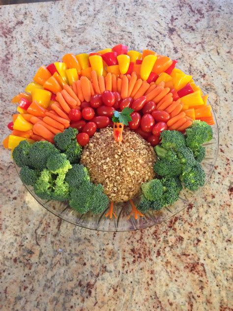 Find thanksgiving appetizers recipes for dips, savory tartlets, cheese spreads, crudite, and more. Fun thanksgiving appetizer :) cheese ball in the middle covered in pecans with veggies all ...