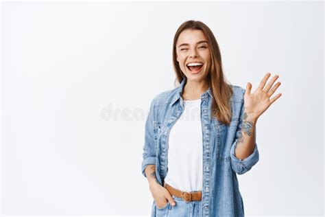 Cheerful Friendly Girl Saying Hello Winking And Smiling Waving Hand